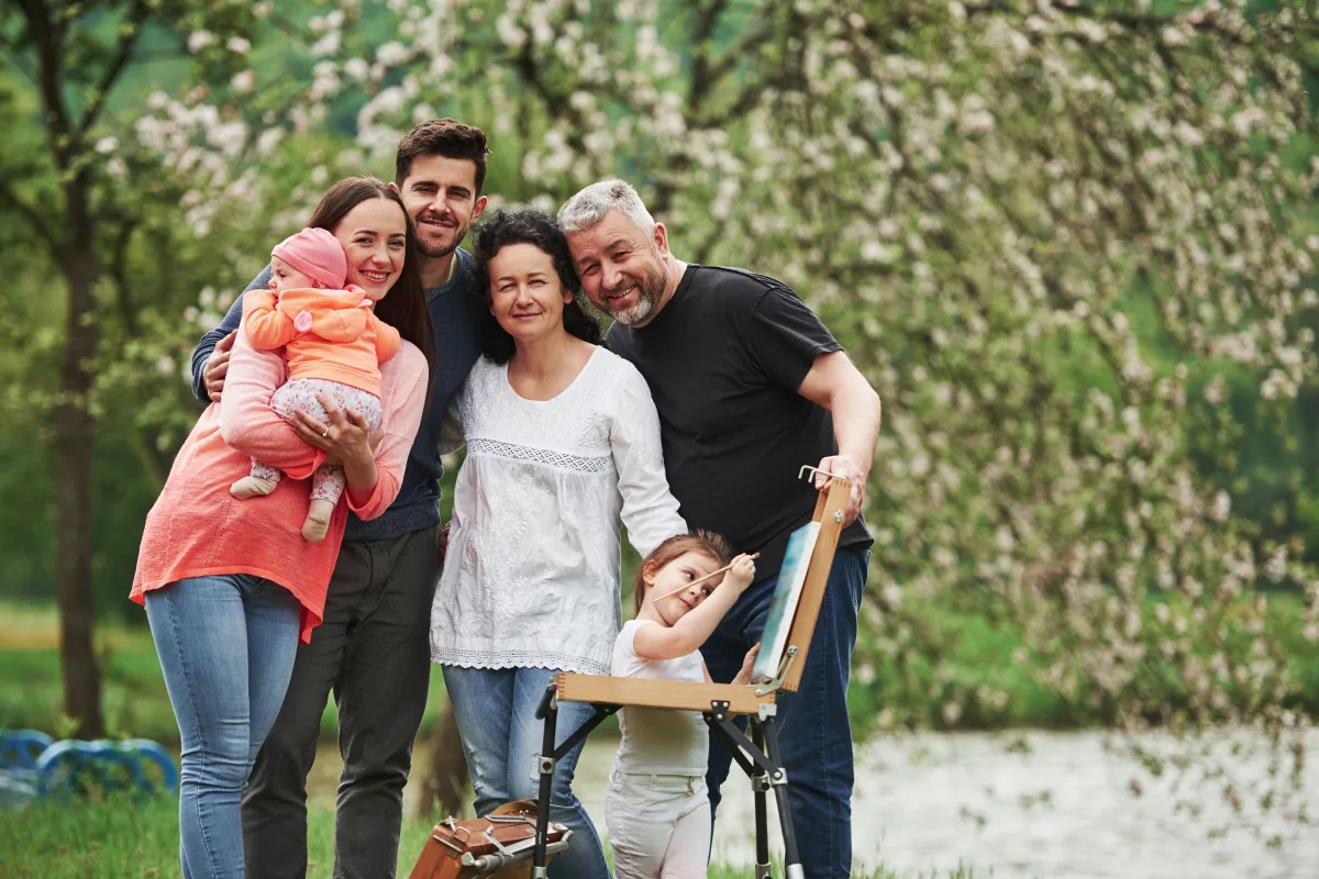 Three generations of a family standing together outdoors